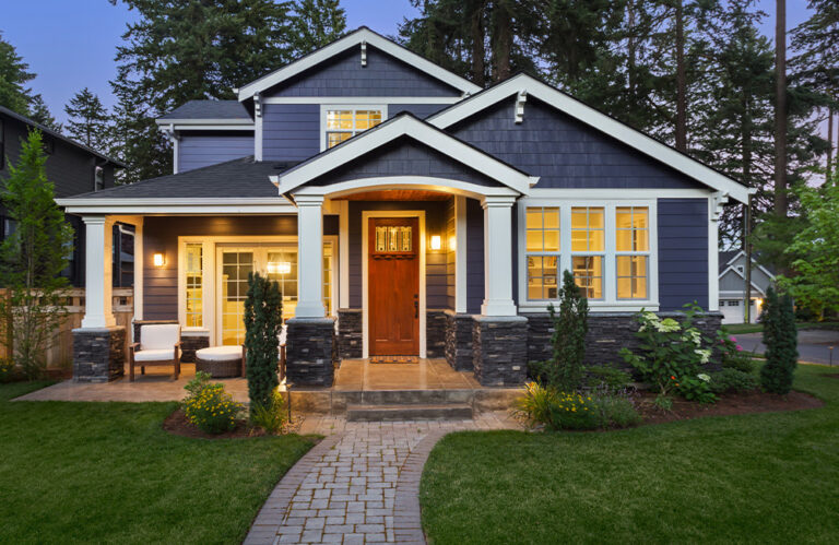 house in the summer at night with lights on