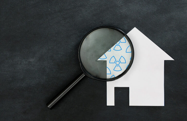 magnifying glass revealing unseen radon in a home